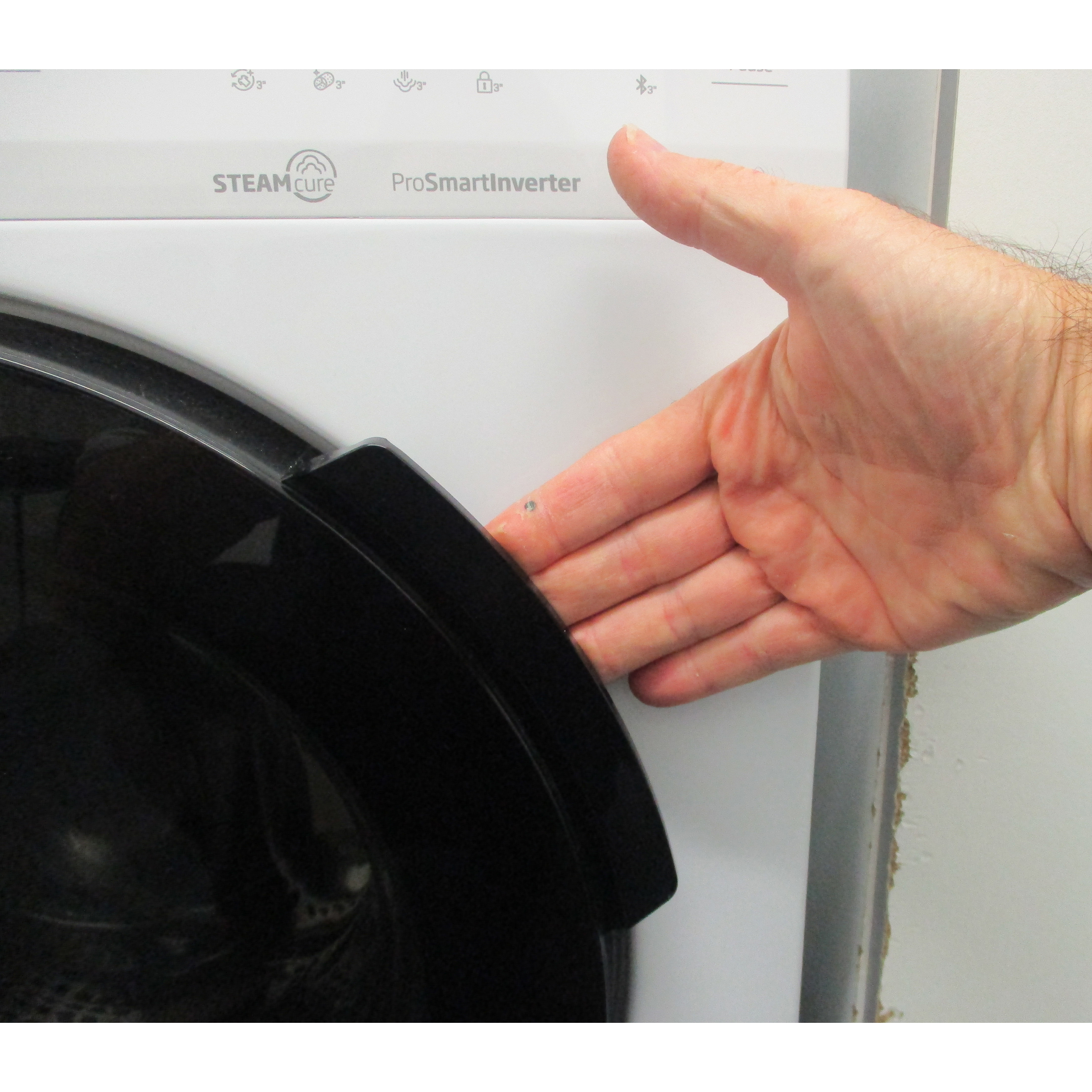 Beko HTE7614YBST - Poignée d'ouverture du hublot